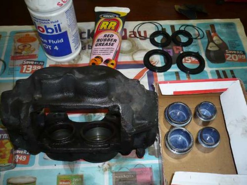 Front brake caliper stripped for cleaning.JPG